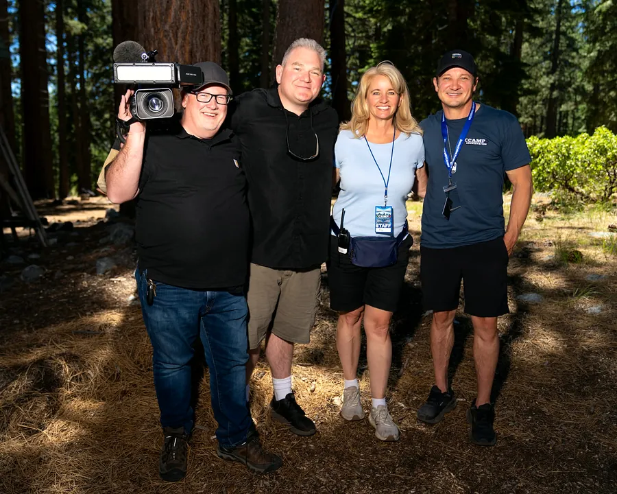 Jeremy Renner with the camp production and staff team in the pines
