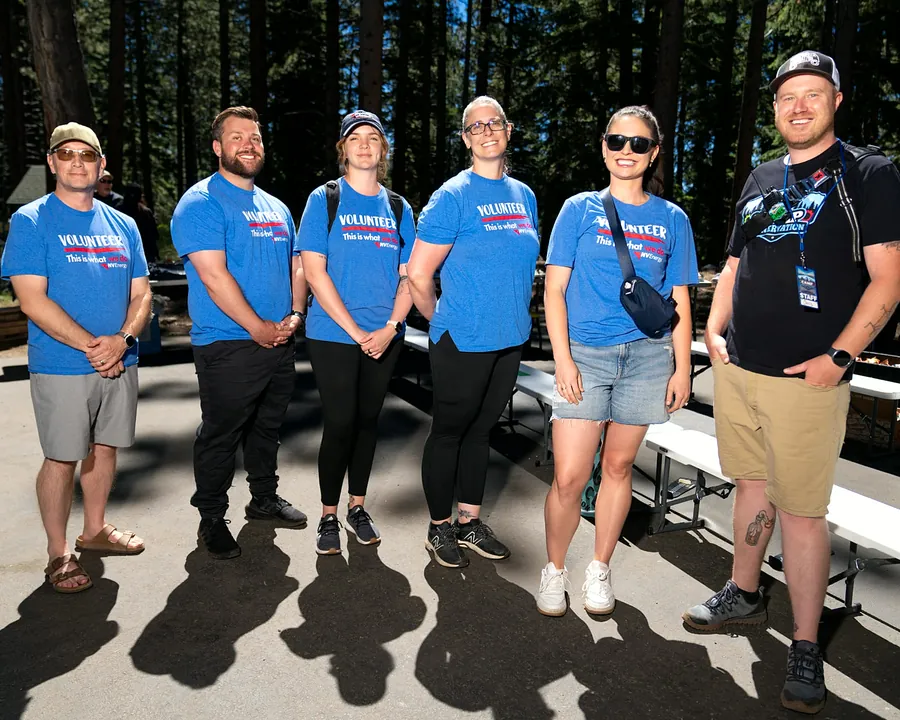 Volunteers in blue shirts serving at Camp Rennervation